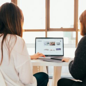 Two women looking at a website