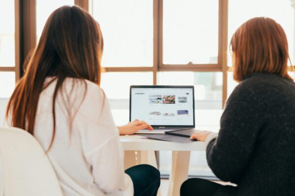 Two women looking at a website